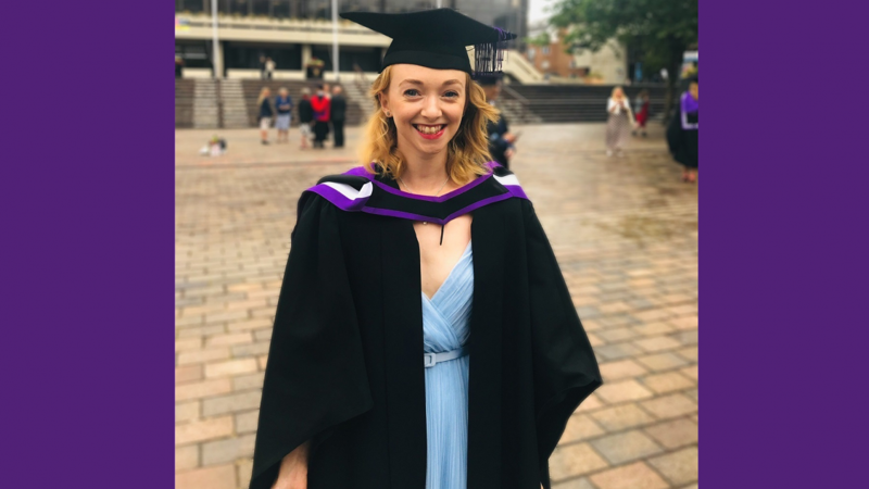 Billie in graduation gown and mortarboard hat.