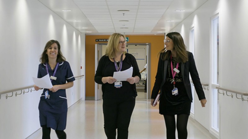 Nurses and practitioners walking down a corridor