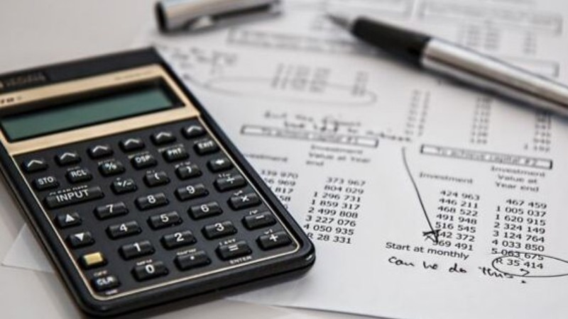 calculator and pen on a table