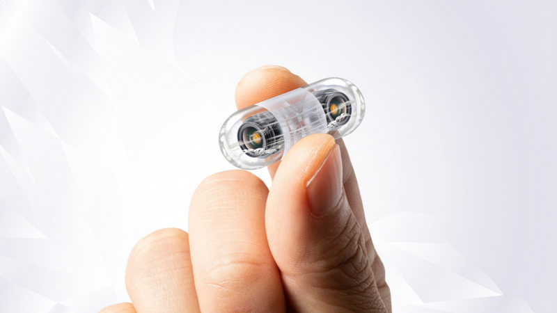 hand holding pill camera