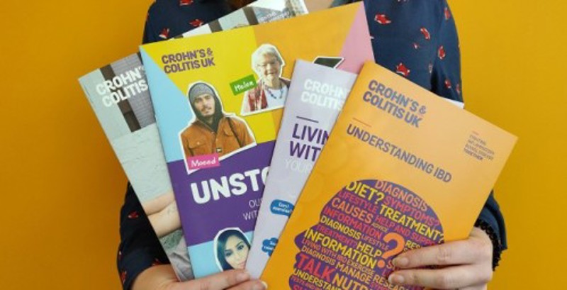 person holding brochures