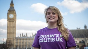 Woman standing in front of the houses of parliament.