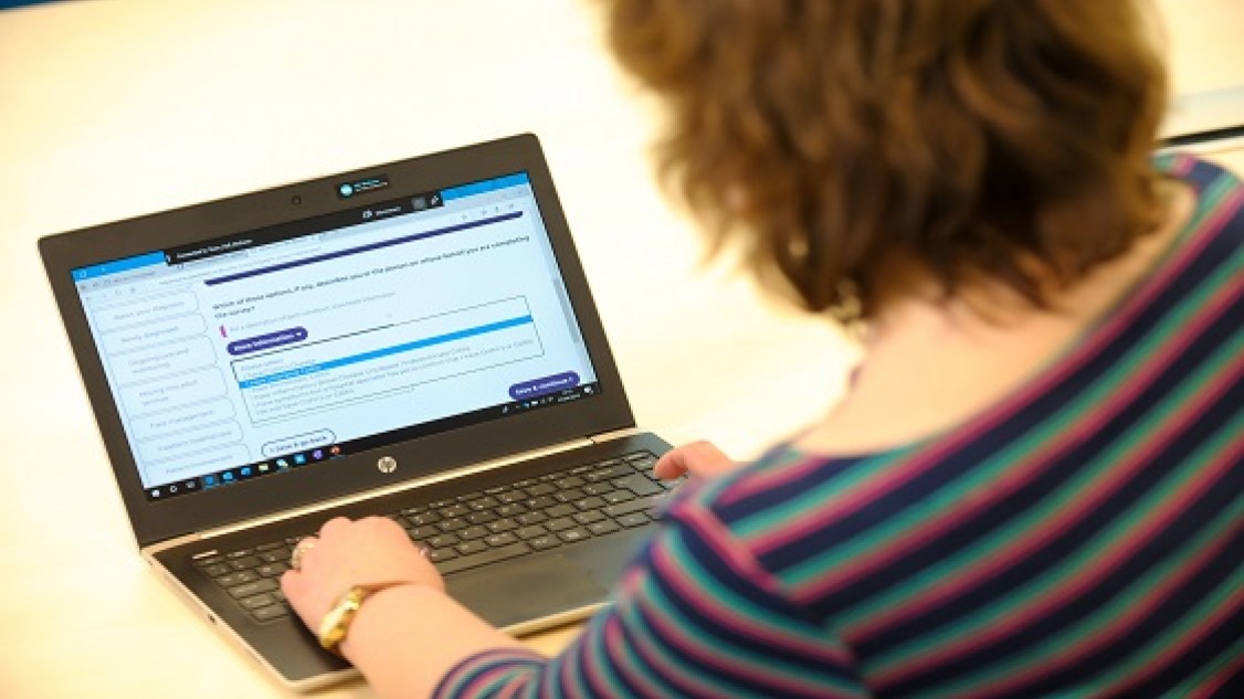 Woman on laptop completing a survey