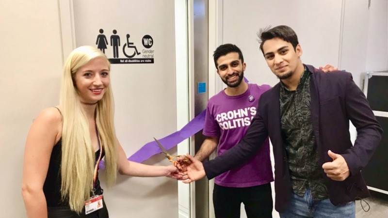 King's College London students cutting the purple tape to open the new accessible toilet.